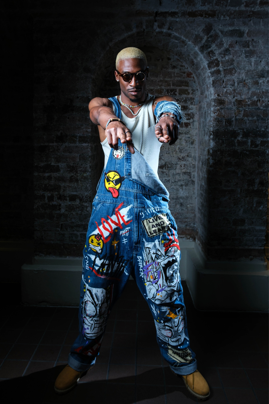 Levi's Denim Overalls in blue denim featuring colorful hand-painted cartoon artwork, patches, and graffiti-style details.