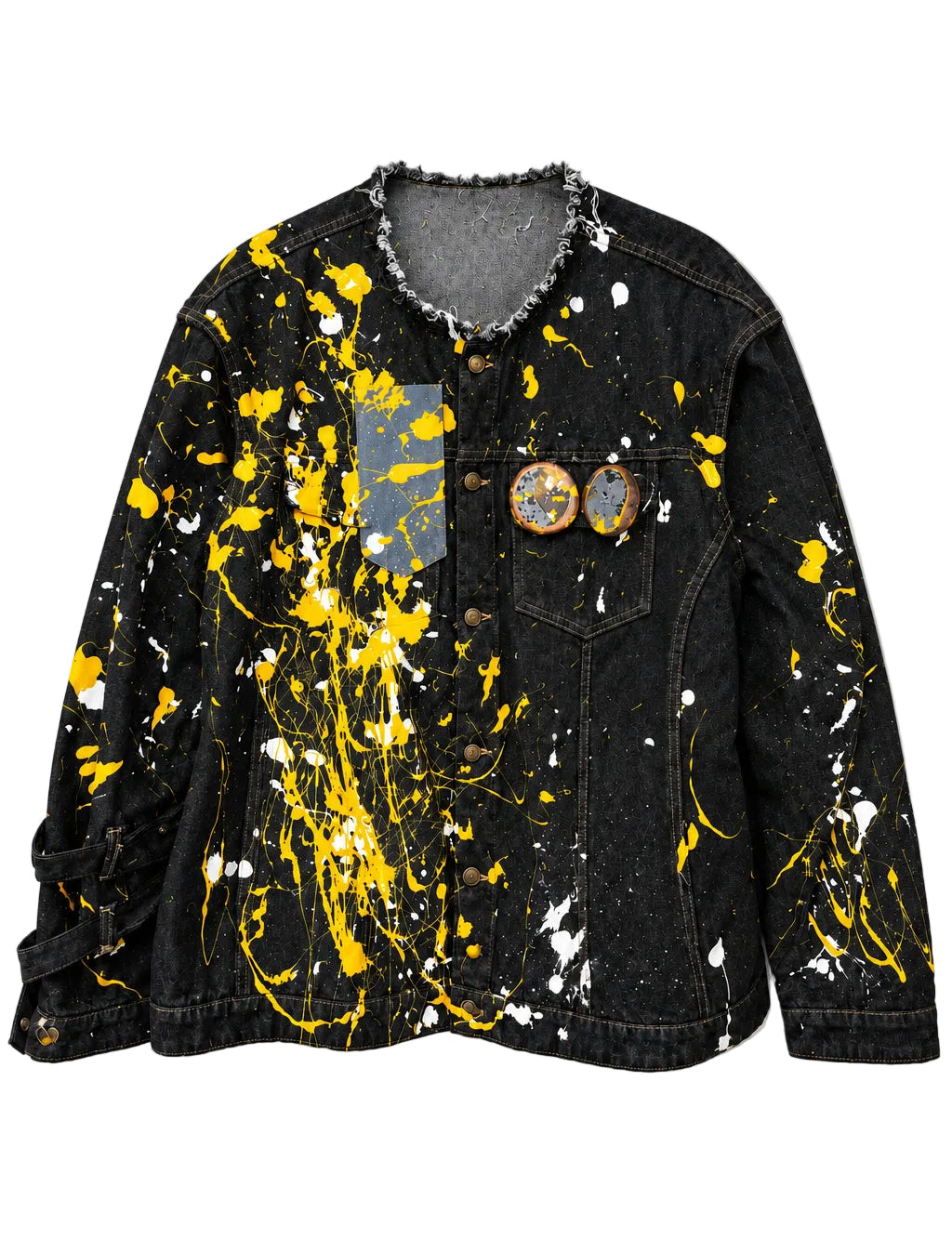 "Urban Ghost" Denim Jacket in black denim with yellow and white paint splatters, distressed raw-edge collar and two portrait pins on chest.