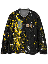 "Urban Ghost" Denim Jacket in black denim with yellow and white paint splatters, distressed raw-edge collar and two portrait pins on chest.